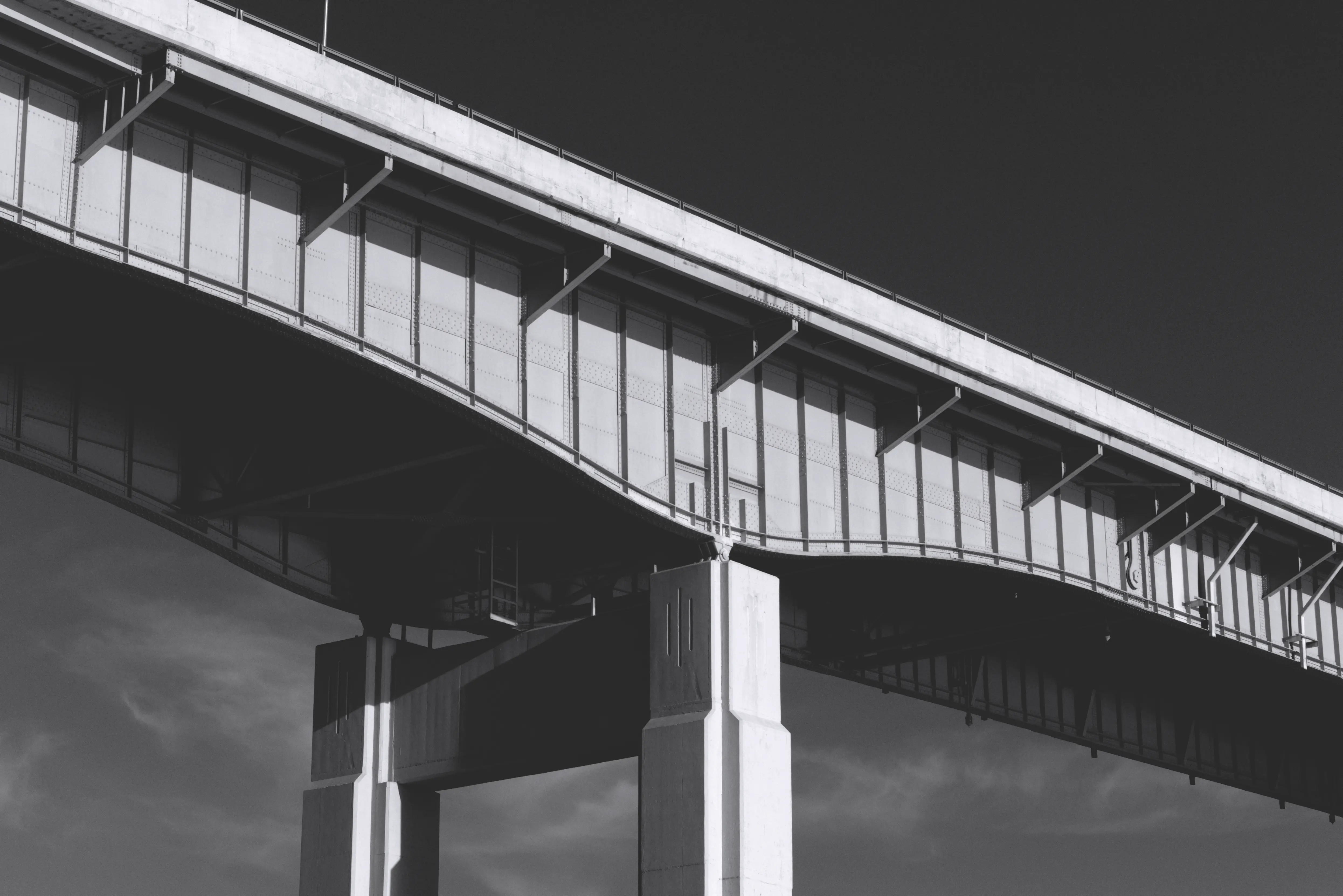 Black and white photo of the underside of a bridge in Buffalo, NY that shows a interesting three line design.