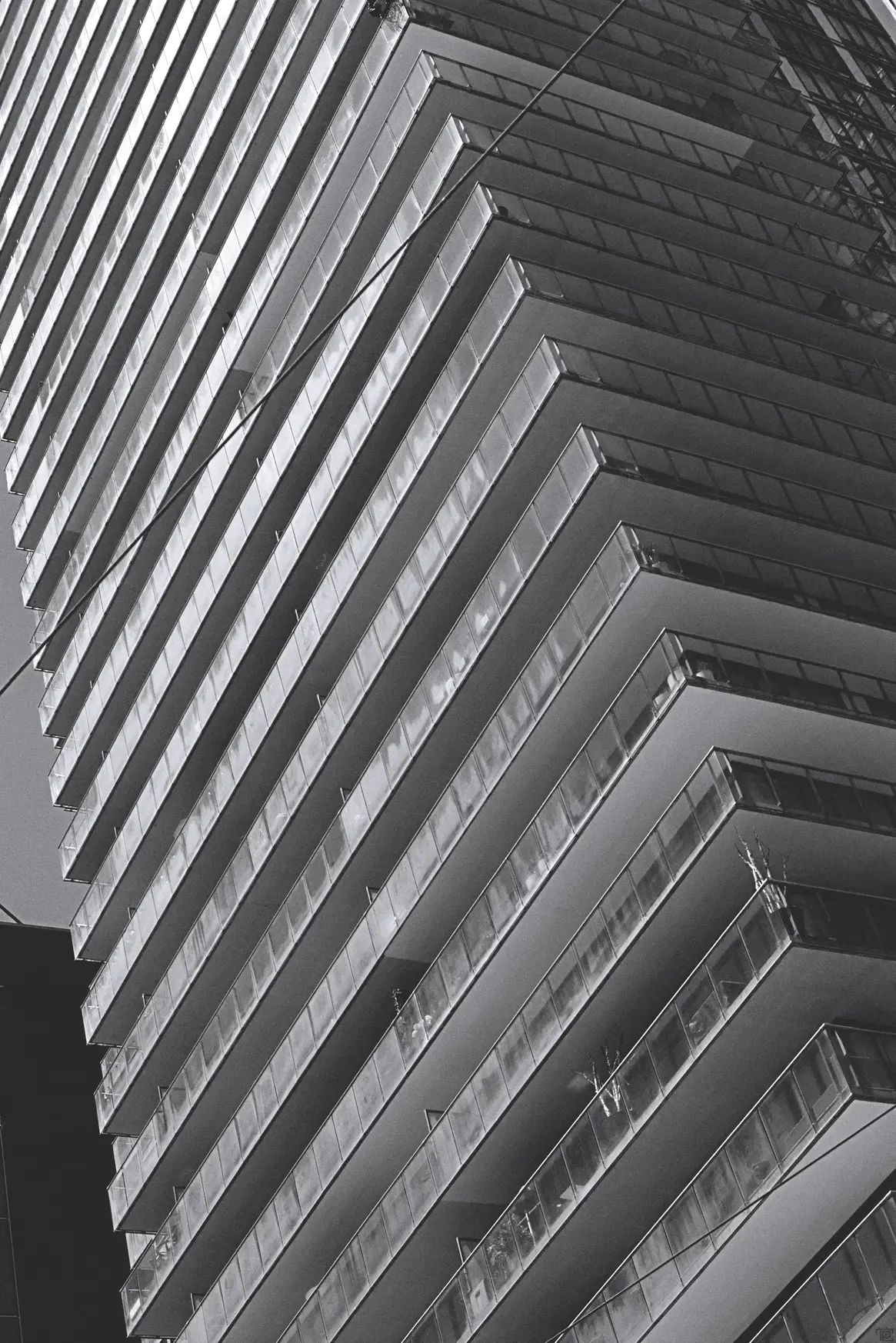 A large appartment building in Toronto, CA shot in black & white with a dutch angle.