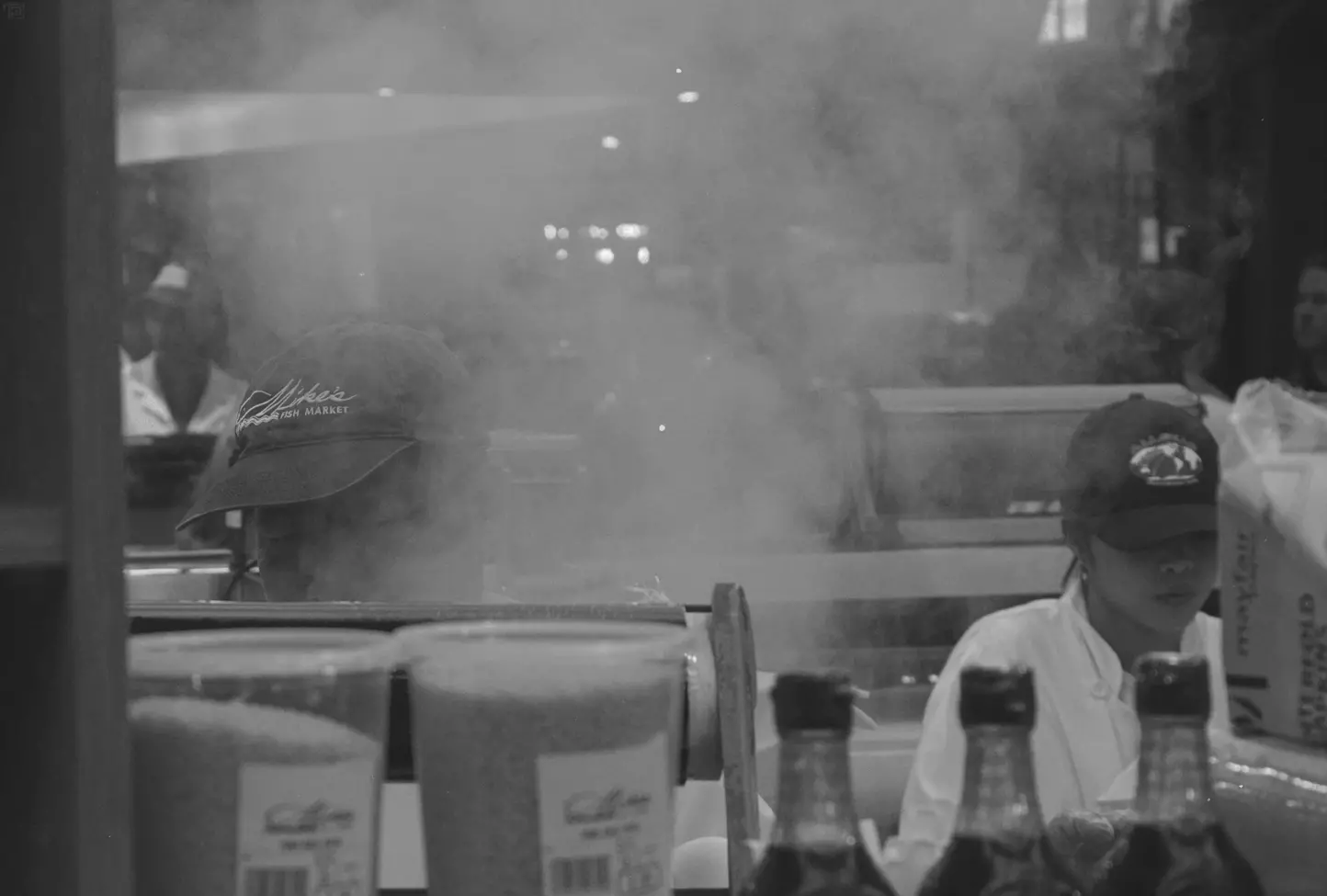 Mike's Fish Market in St. Lawrence Market showing a cloud of steam rising in front of a workers face obscuring them a bit behind the cloud.