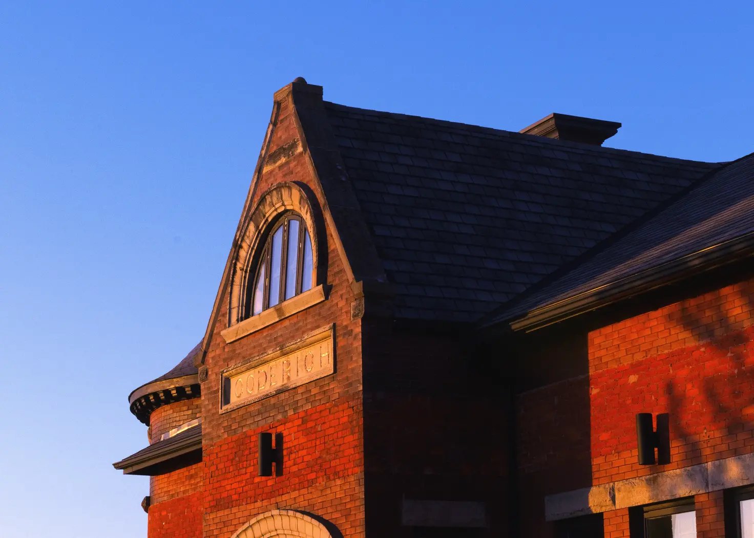 Outside a building in Goderich, CA showing the name of the location with the colors vibrancy cranked up.