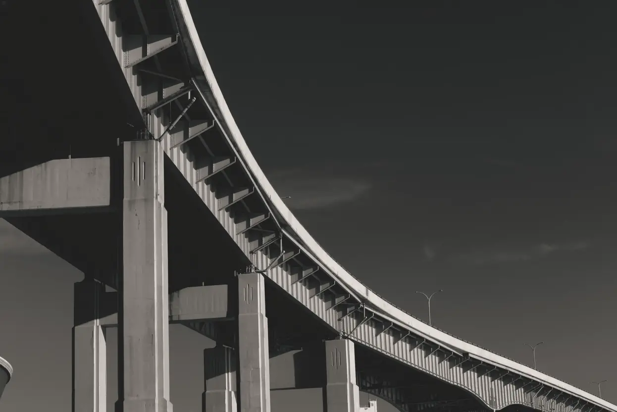 The underside of a bridge shot in black and white